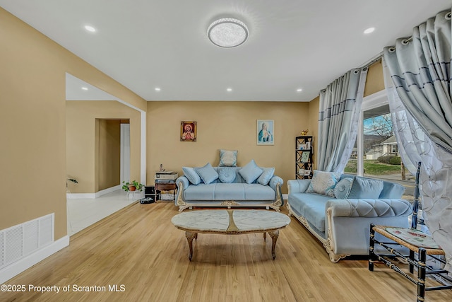 living area with wood finished floors, recessed lighting, and visible vents