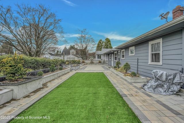 view of yard featuring fence and a patio