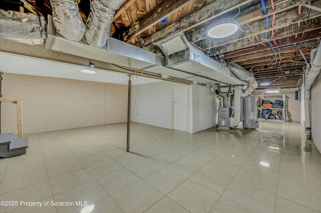 unfinished below grade area with heating unit, water heater, and tile patterned flooring