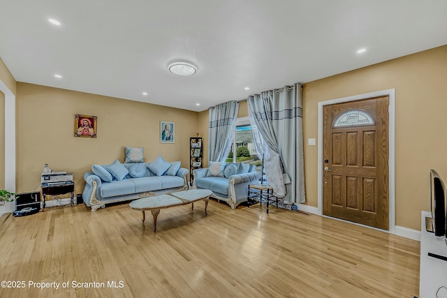 living room with baseboards, light wood-style floors, and recessed lighting
