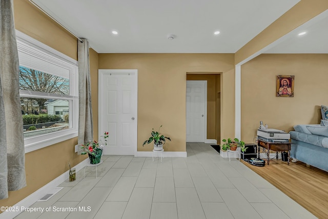 entryway featuring baseboards, wood finished floors, and recessed lighting