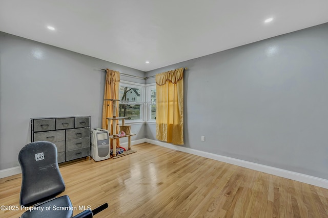 interior space featuring baseboards, wood finished floors, and recessed lighting