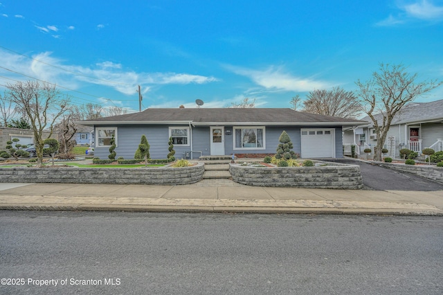 ranch-style home with driveway and an attached garage