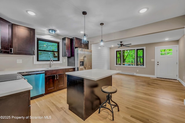 40 Honey Bear Rd, Lake Ariel, PA 18436 - kitchen with stainless steel fridge, a sink, dishwasher, a baseboard radiator, and light wood-style flooring