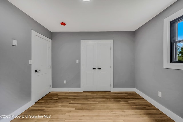 40 Honey Bear Rd, Lake Ariel, PA 18436 - unfurnished bedroom featuring light wood finished floors, baseboards, and a closet