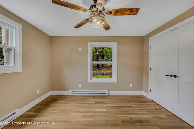 40 Honey Bear Rd, Lake Ariel, PA 18436 - unfurnished bedroom featuring a baseboard radiator, light wood-style flooring, and baseboards