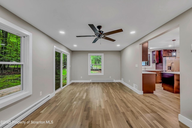 40 Honey Bear Rd, Lake Ariel, PA 18436 - unfurnished living room with a baseboard heating unit, baseboard heating, light wood-style floors, baseboards, and recessed lighting