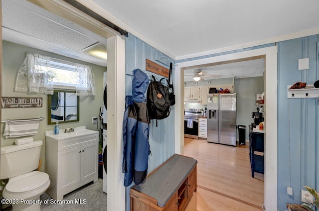 bathroom featuring vanity, hardwood / wood-style flooring, toilet, and ceiling fan