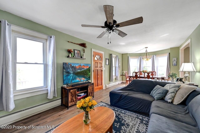 living room with ceiling fan, a baseboard radiator, and hardwood / wood-style flooring