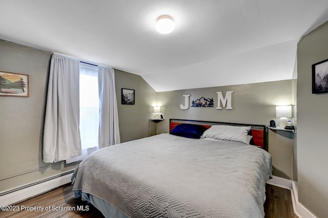 bedroom featuring dark wood-type flooring, a baseboard radiator, and lofted ceiling