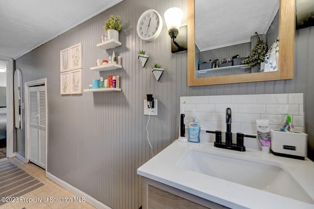 bathroom with tile patterned floors, vanity, and ornamental molding