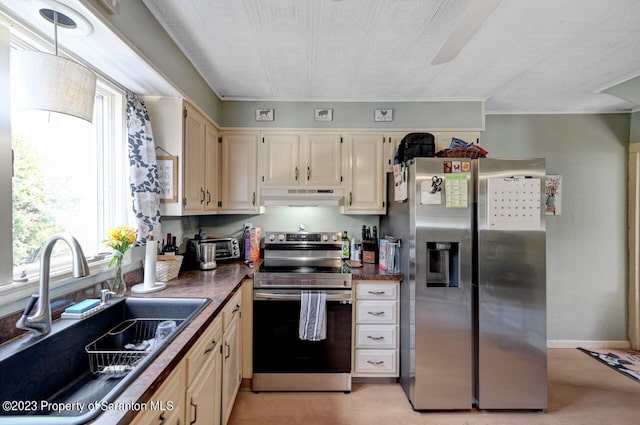 kitchen featuring cream cabinetry, sink, and appliances with stainless steel finishes