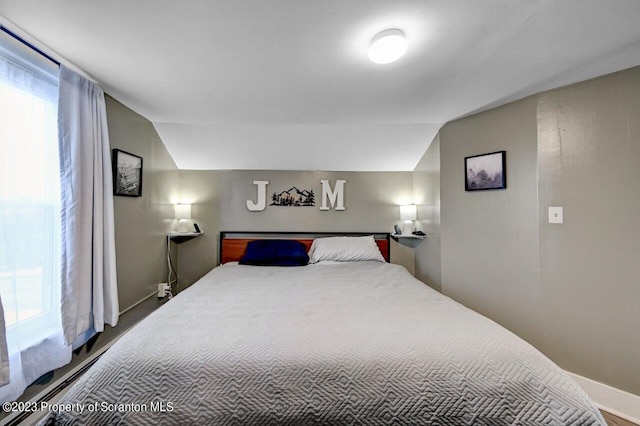 bedroom featuring vaulted ceiling