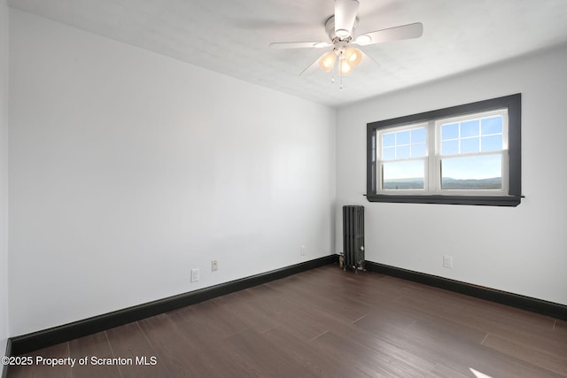 1210 N N Main Ave, Scranton, PA 18508 - empty room with radiator, dark wood finished floors, and ceiling fan