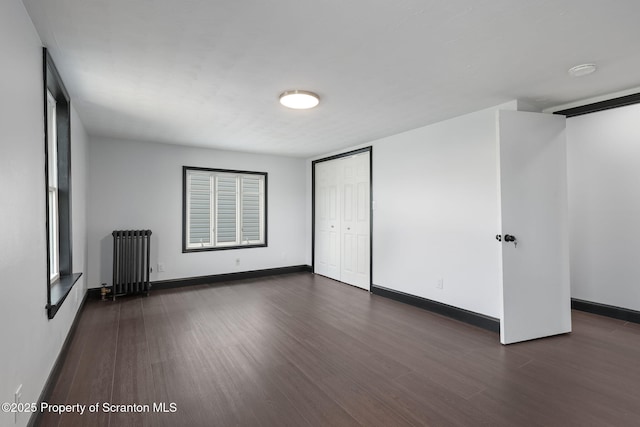 1210 N N Main Ave, Scranton, PA 18508 - unfurnished living room featuring radiator heating unit and dark wood-type flooring