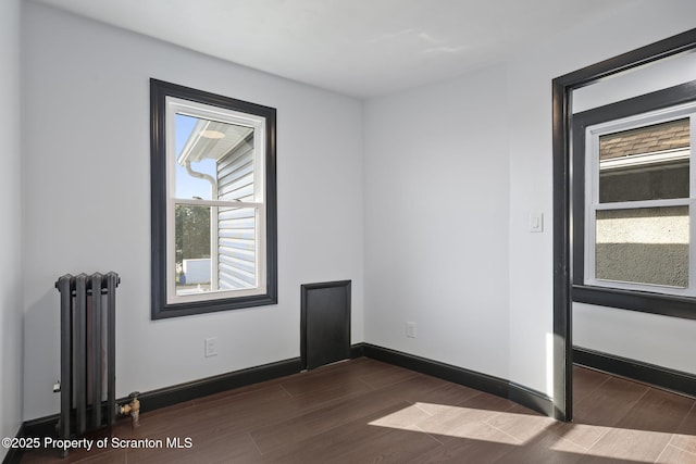 1210 N N Main Ave, Scranton, PA 18508 - empty room featuring radiator heating unit and dark wood-style flooring