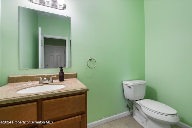 bathroom featuring tile patterned flooring, vanity, and toilet