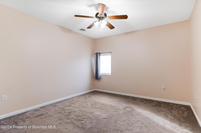 empty room featuring carpet flooring and ceiling fan