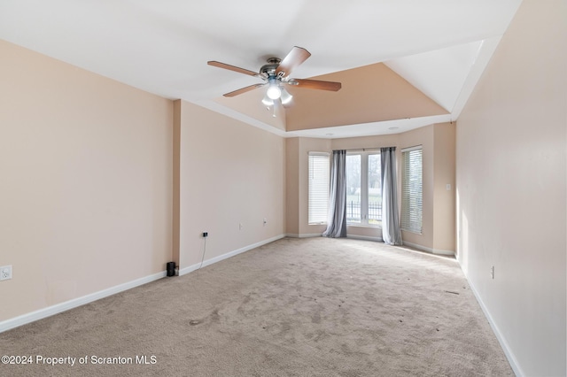 empty room with ceiling fan, light carpet, and vaulted ceiling