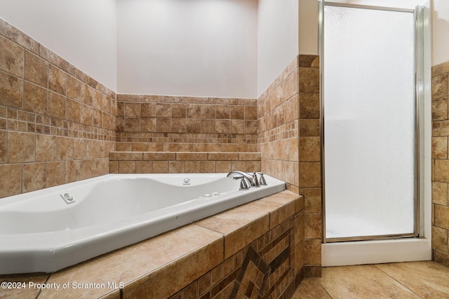 bathroom featuring tile patterned floors and tiled bath