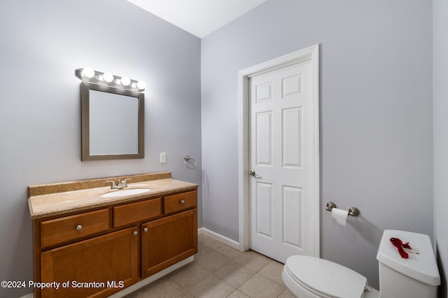 bathroom featuring tile patterned flooring, vanity, and toilet