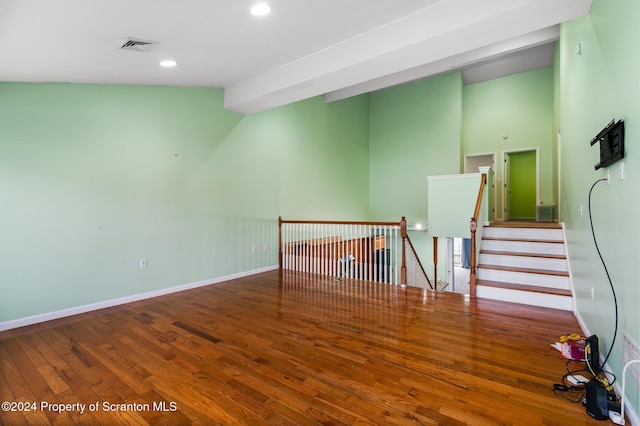 unfurnished room with wood-type flooring and lofted ceiling