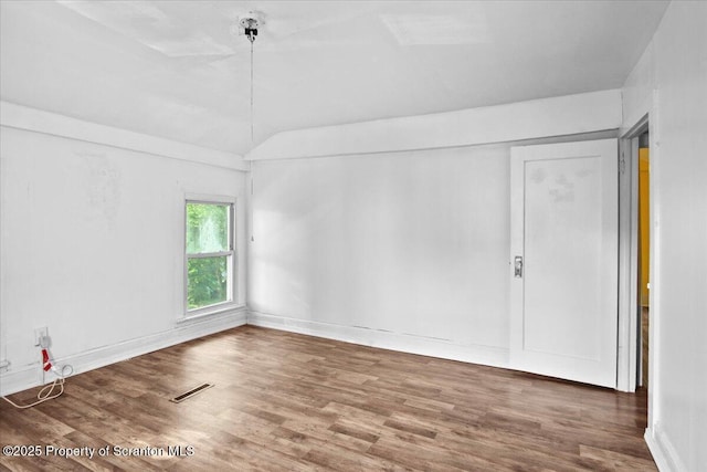 1017 W Market St, Scranton, PA 18508 - empty room featuring wood finished floors and lofted ceiling