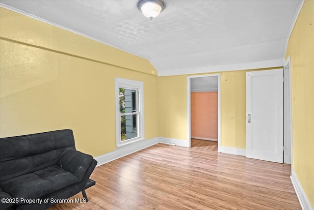 1017 W Market St, Scranton, PA 18508 - living area featuring wood finished floors, a textured ceiling, and lofted ceiling
