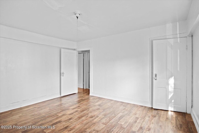 1017 W Market St, Scranton, PA 18508 - empty room with wood finished floors and baseboards