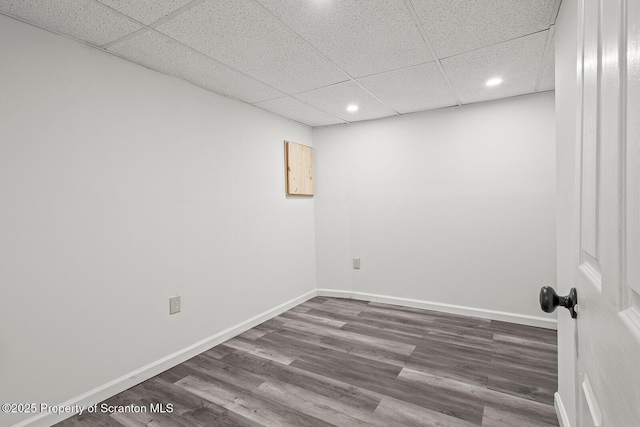 spare room featuring hardwood / wood-style flooring and a paneled ceiling