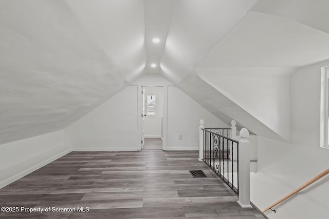 bonus room featuring hardwood / wood-style flooring and vaulted ceiling