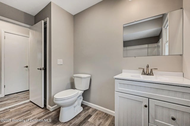 bathroom featuring hardwood / wood-style floors, vanity, and toilet