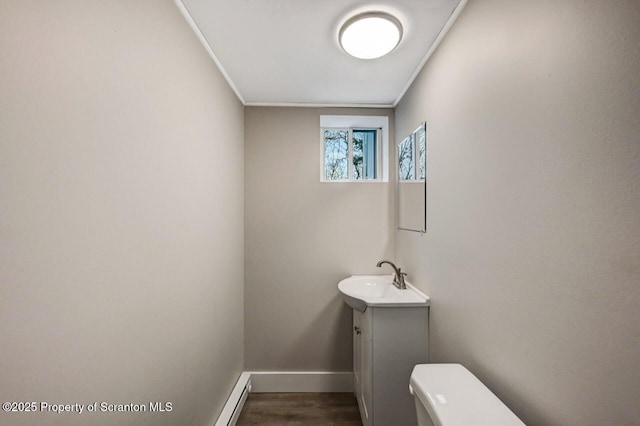 bathroom featuring vanity, hardwood / wood-style flooring, toilet, and crown molding