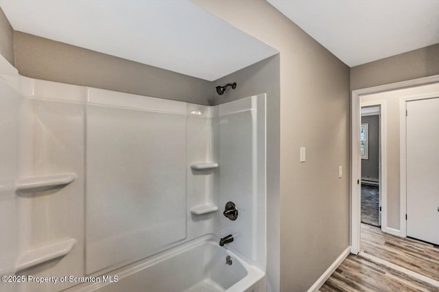 bathroom with hardwood / wood-style floors and shower / tub combination