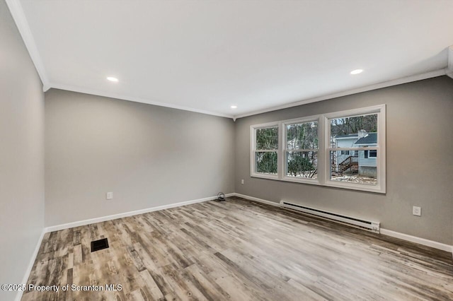 unfurnished room featuring hardwood / wood-style floors, crown molding, and a baseboard radiator