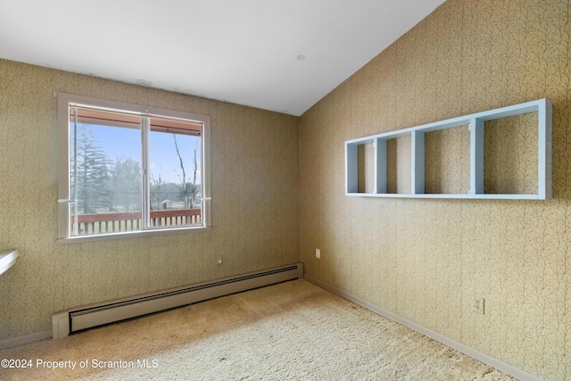 unfurnished room featuring carpet floors, lofted ceiling, and a baseboard heating unit