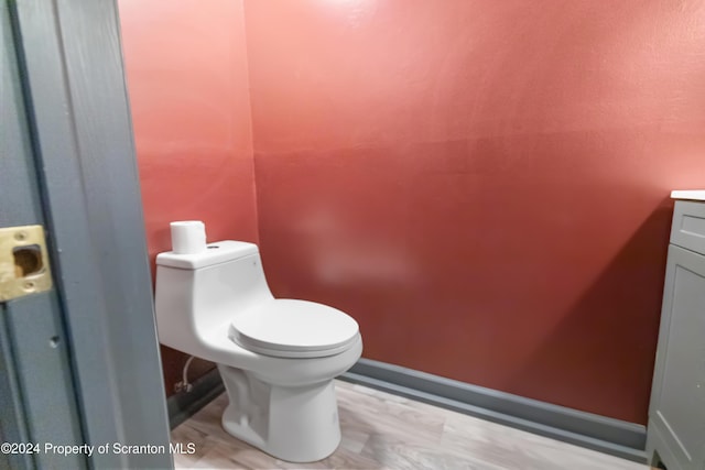 bathroom featuring hardwood / wood-style flooring, vanity, and toilet