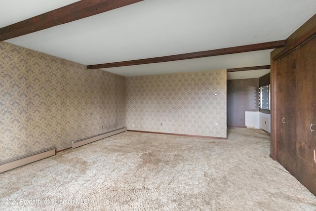 carpeted spare room with beamed ceiling and a baseboard heating unit