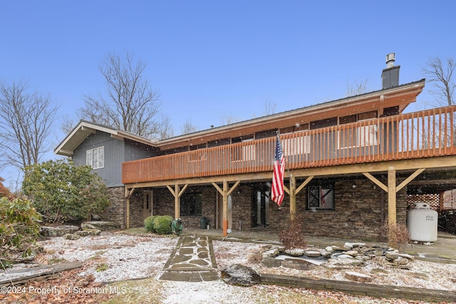 snow covered house featuring a deck