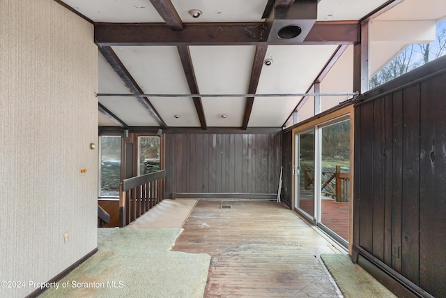 unfurnished sunroom featuring lofted ceiling with beams and coffered ceiling