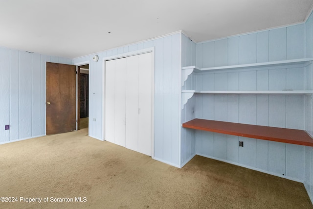 unfurnished bedroom with carpet floors and a closet