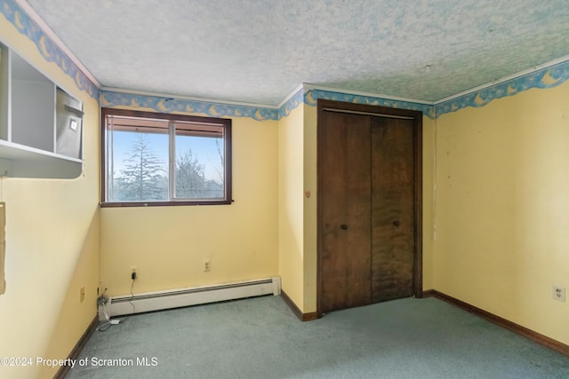 unfurnished bedroom with a closet, carpet floors, a baseboard radiator, and a textured ceiling