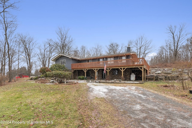 view of front of home with a front yard and a deck