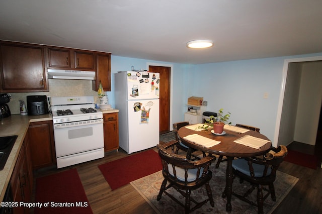 528 Hemlock St, Scranton, PA 18505 - kitchen with white appliances, under cabinet range hood, dark wood-style floors, light countertops, and dark brown cabinets