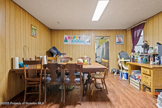 1004 Prospect Ave, Scranton, PA 18505 - dining room with wood finished floors, wood walls, and a textured ceiling