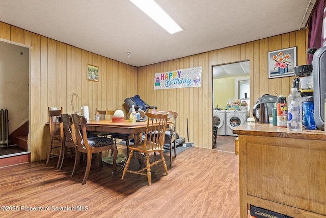 1004 Prospect Ave, Scranton, PA 18505 - dining room with separate washer and dryer, wood finished floors, wooden walls, and radiator