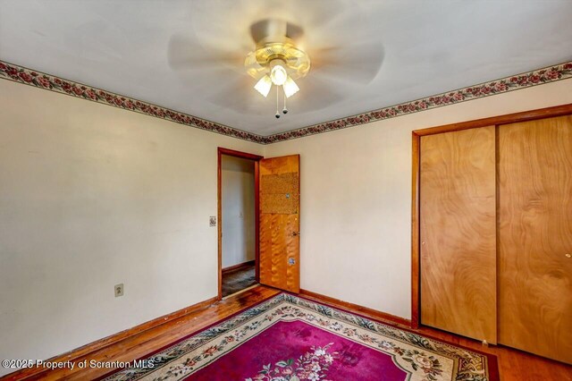 226 Linda Ln, Scranton, PA 18504 - unfurnished bedroom featuring wood finished floors, a closet, and ceiling fan