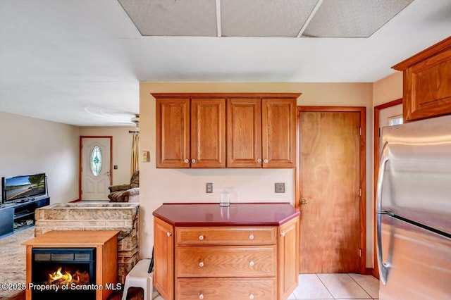226 Linda Ln, Scranton, PA 18504 - kitchen with freestanding refrigerator, brown cabinetry, and light tile patterned floors