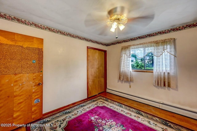226 Linda Ln, Scranton, PA 18504 - empty room featuring a baseboard heating unit, a ceiling fan, and wood finished floors