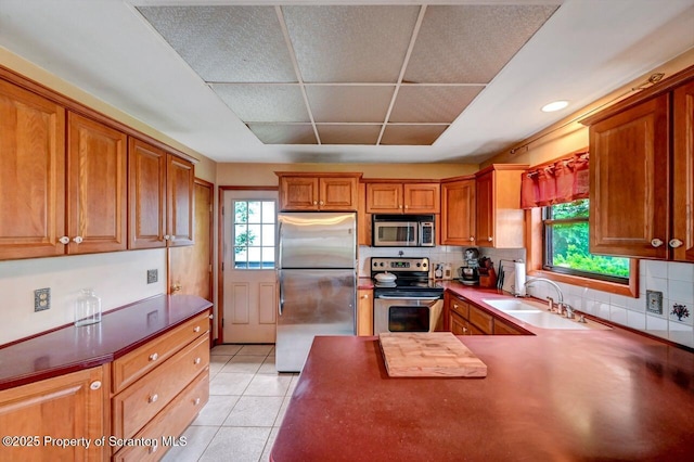 226 Linda Ln, Scranton, PA 18504 - kitchen featuring stainless steel appliances, healthy amount of natural light, backsplash, and brown cabinets